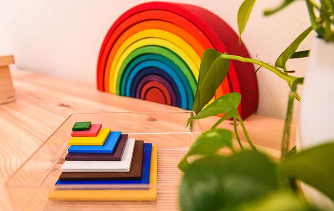 wooden rainbow toys and blocks on counter top