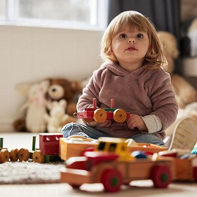 toddler playing with wooden toys