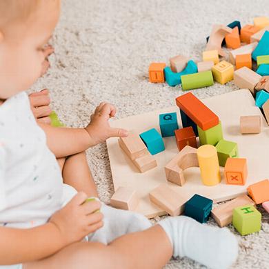 baby playing with wooden blocks